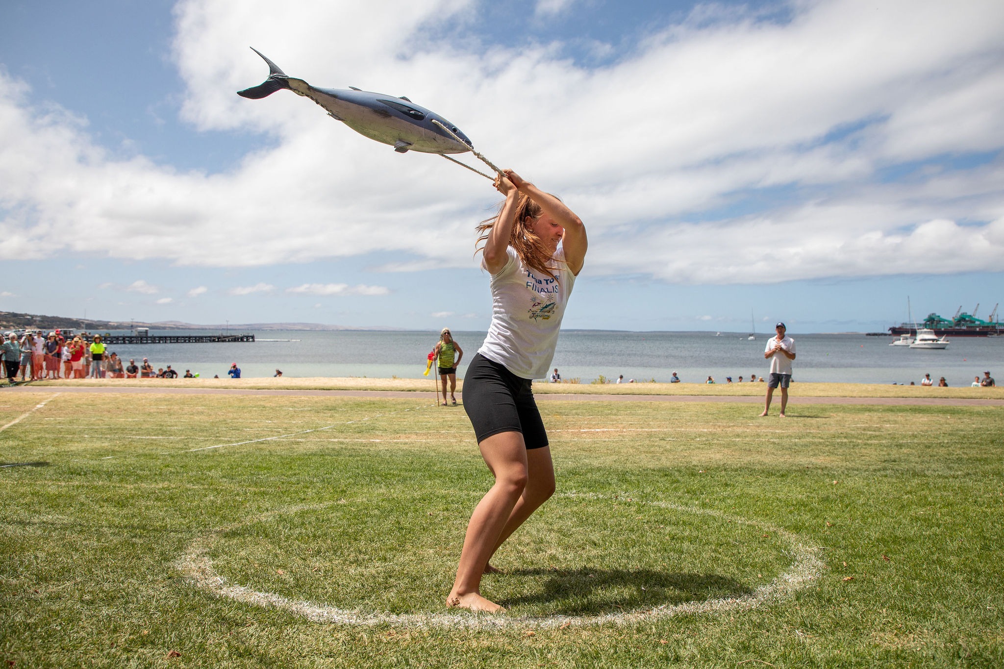 Tuna Toss at Tunarama: a young lady is throwing a 10kg frozen tuna as far as she can in Port Lincoln.