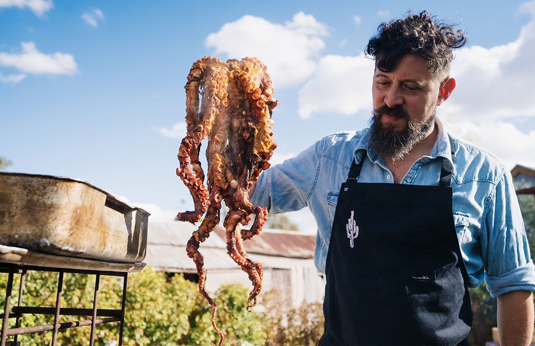 Chef holding octopus ready to cook at Tasting Australia
