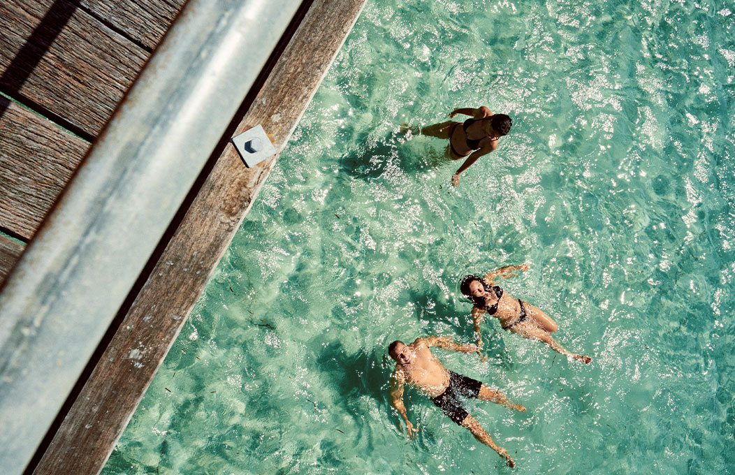 man and woman floating in clear blue shallow sea. Right next to the jetty in Eyre Peninsula, South Australia