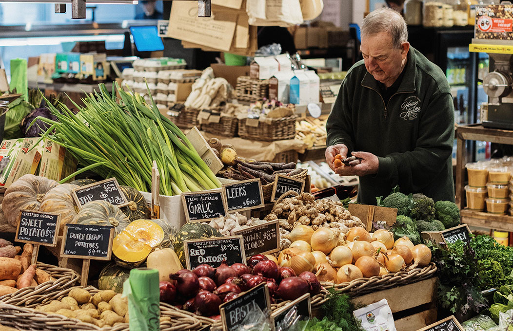 Person selling fruit and vegetables at Adelaide Central Market