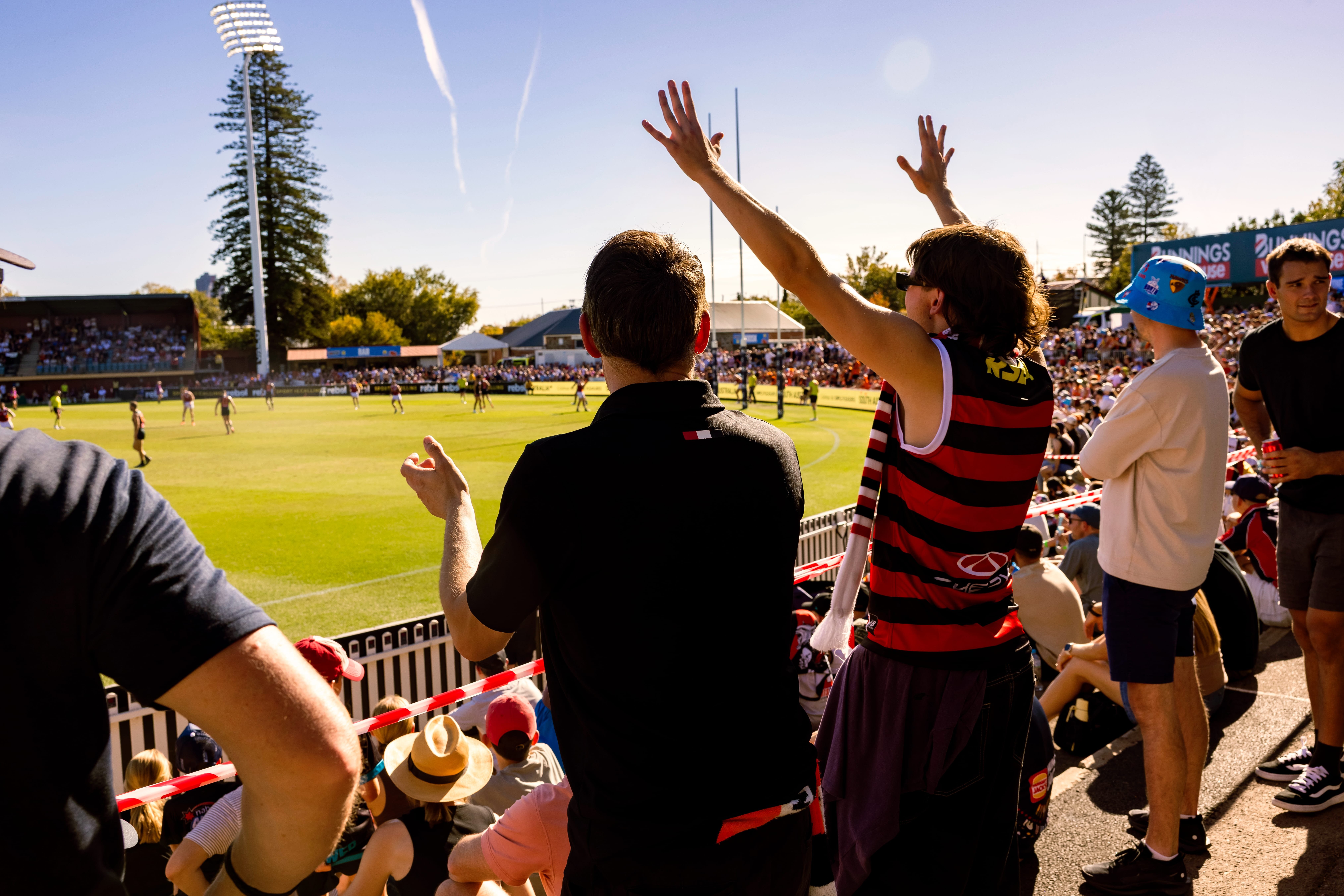 richmond and fremantle dockers afl players reach for the ball mid-air 