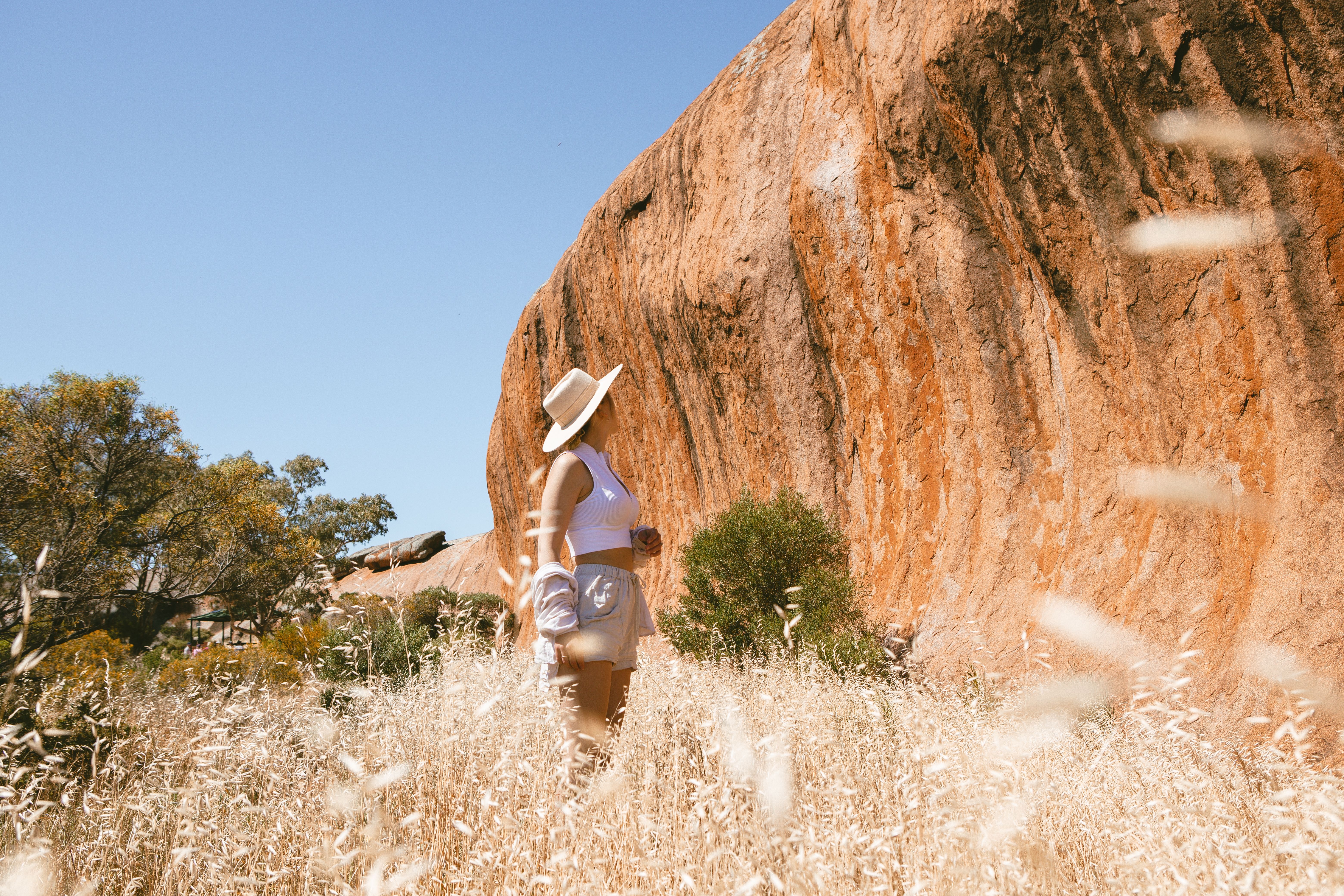 A lady walking by the immensity of Pildappa Rock