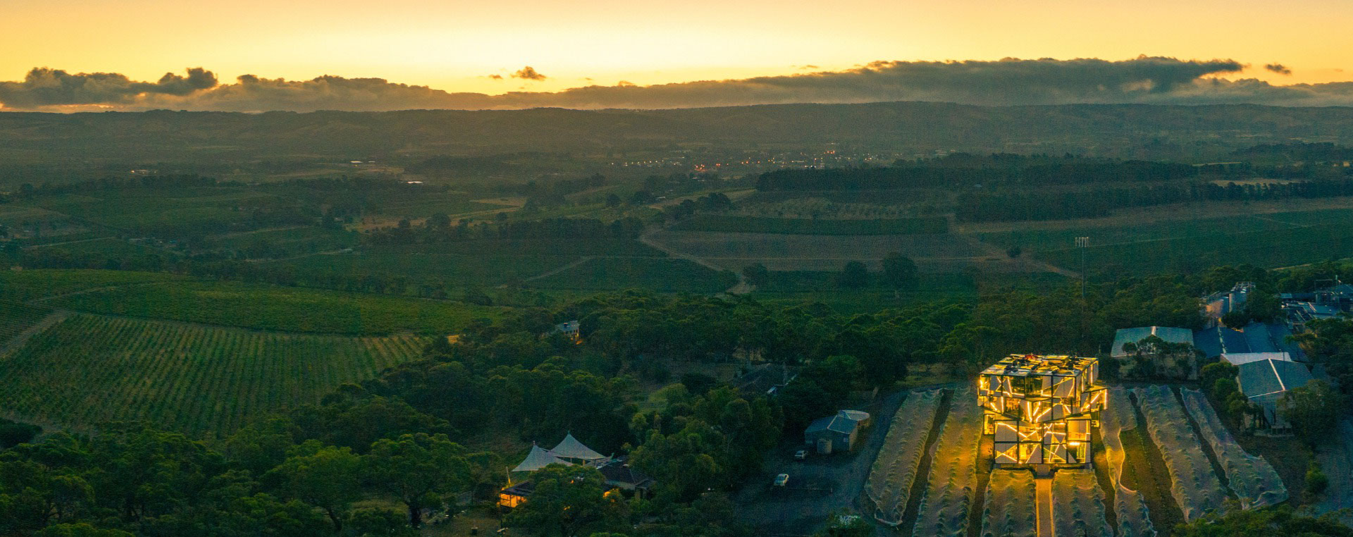 A rubiks cube shaped cellar door sits amongst a sea of vineyards, waiting to share it's winery wonders with the world
