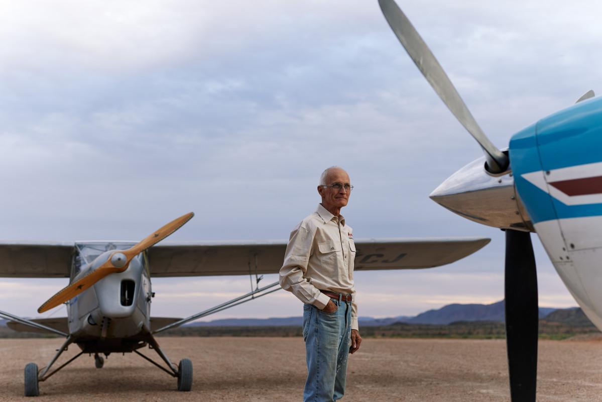 Doug Sprigg standing with his small prop planes